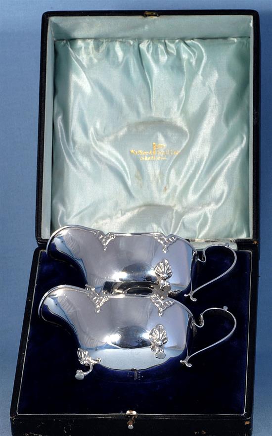 A cased pair of George V silver sauce boats, by Walker & Hall, Length 161mm weight 9.5oz/296grms